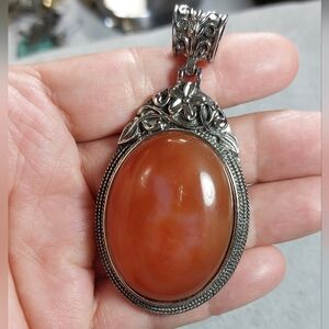 Red agate pendant set in an ornate silver-tone frame. Womens Jewelry